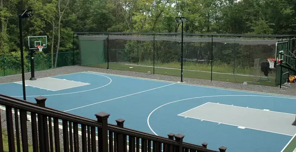 Full-size backyard court with basketball and tennis lines