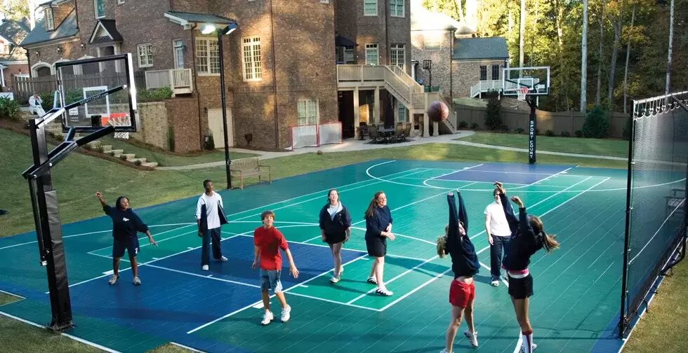 Family playing on a backyard multi-sport game court