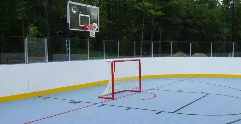Backyard rink surface with boards and hockey net