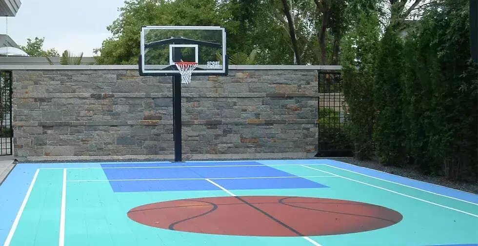 Backyard basketball court with custom stone surround