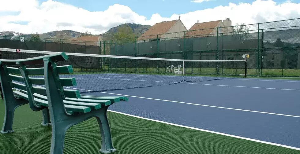 Backyard tennis court with true-bounce surface