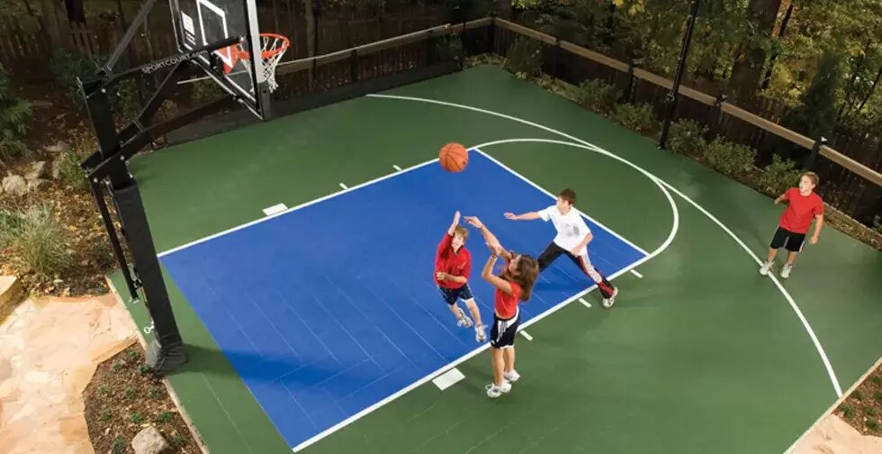 Kids playing on a backyard sport court