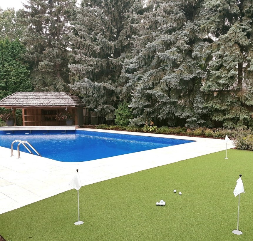 Backyard pool with synthetic putting green