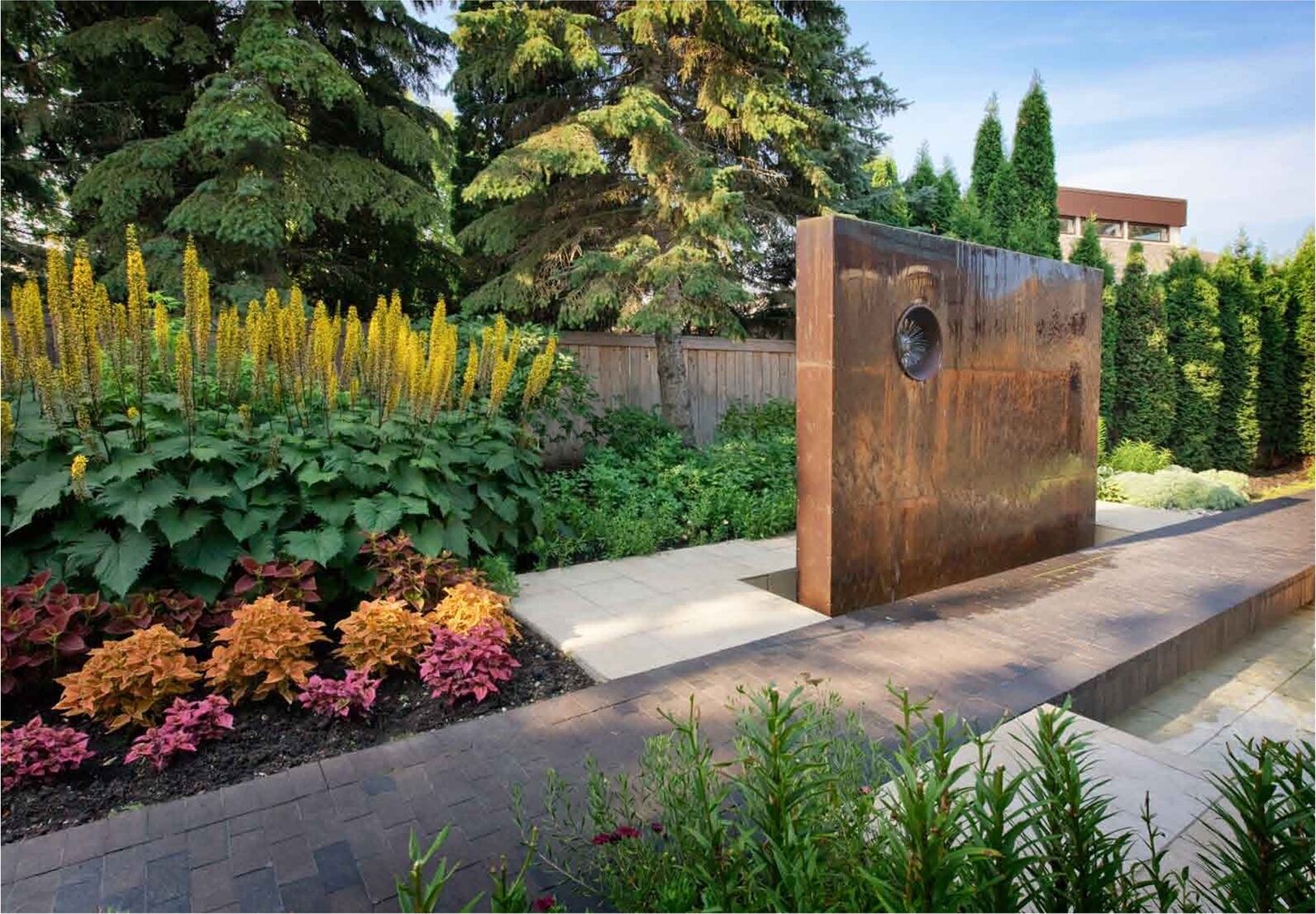 Custom waterwall feature surrounded by plantings at Park Boulevard