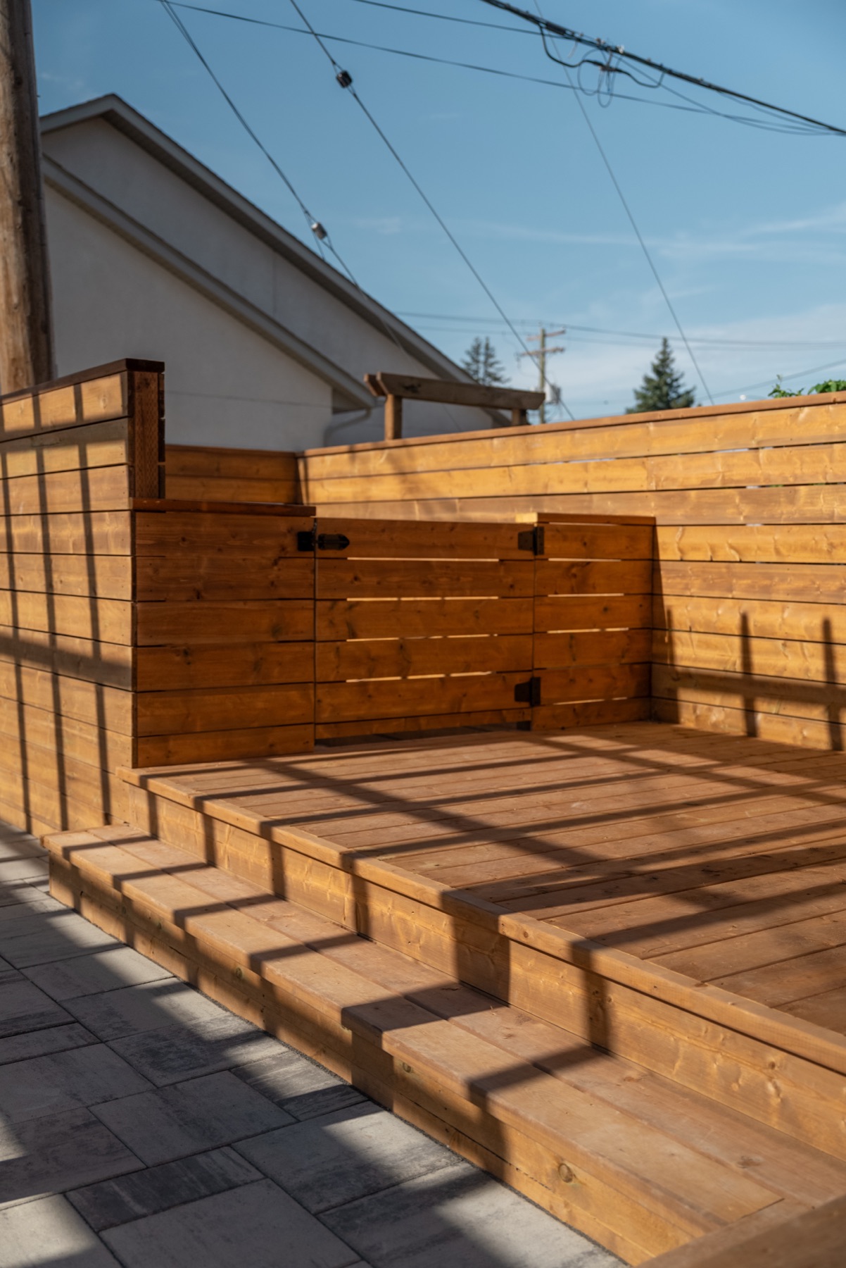 Cedar gate and fence with chevron shadow patterns