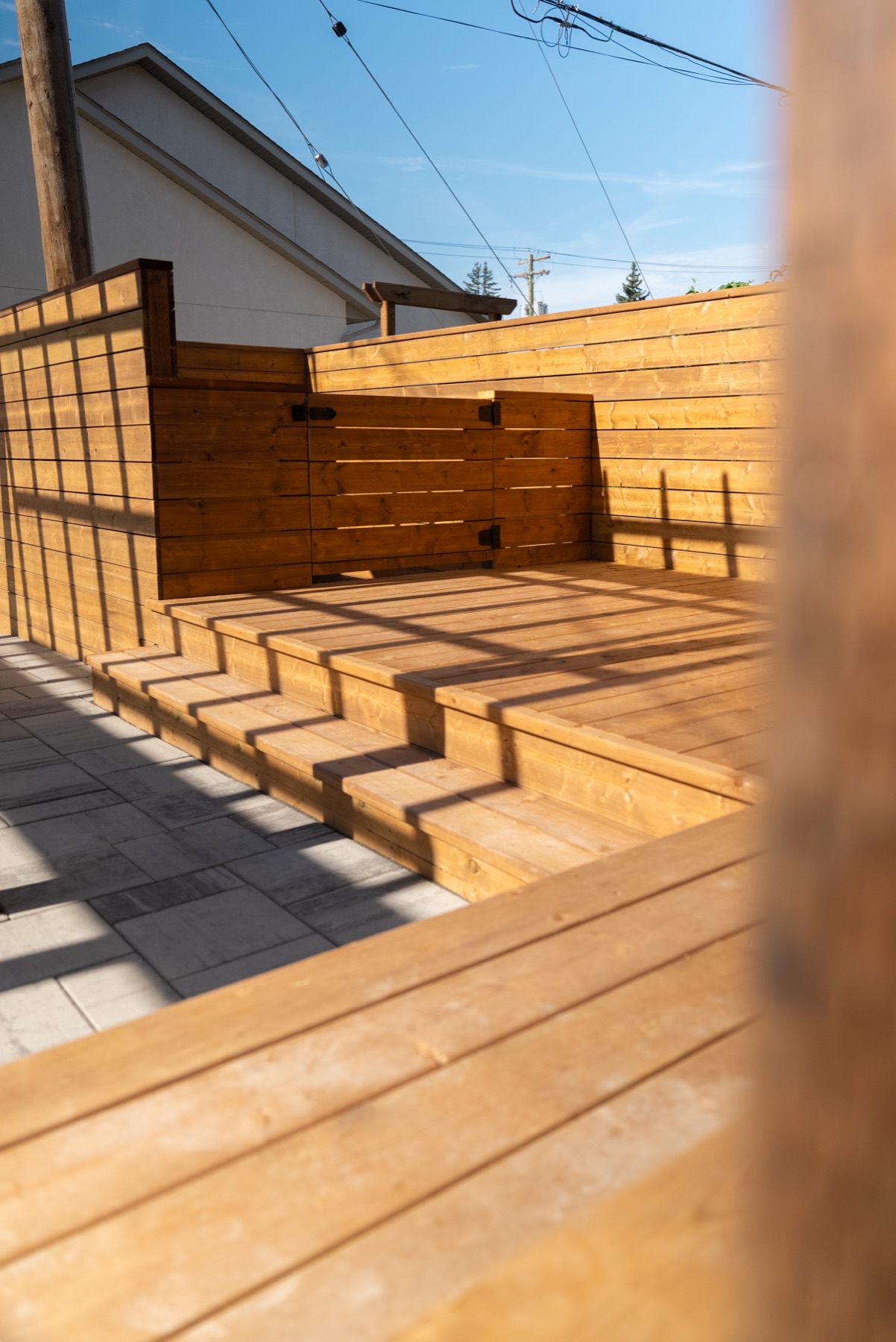 Cedar steps and deck with afternoon shadow lines at Centennial