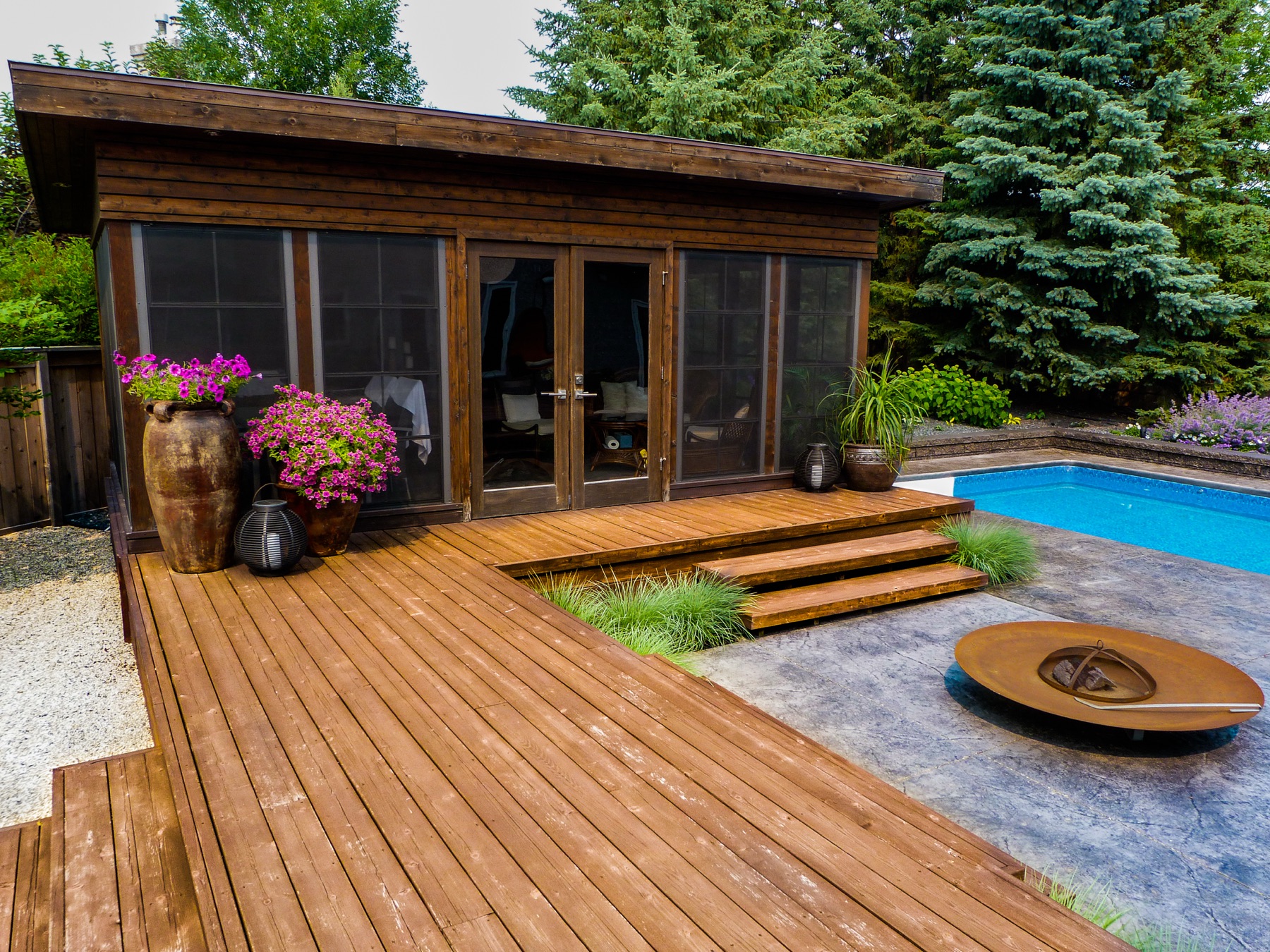 Modern wood deck with pool and circular fire bowl