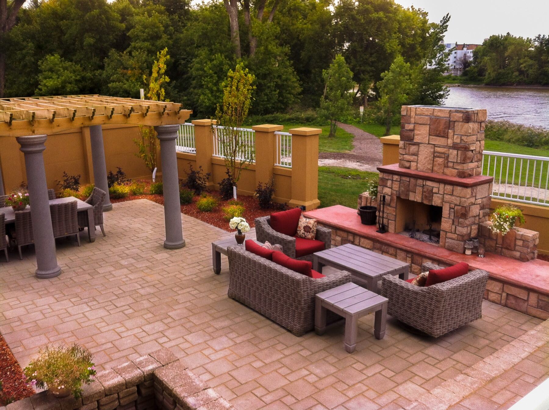 Outdoor fireplace with brick patio and lounge seating