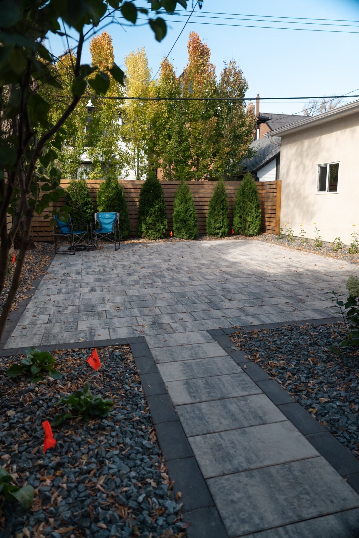 Paver patio with horizontal cedar screening at the Grosvenor project