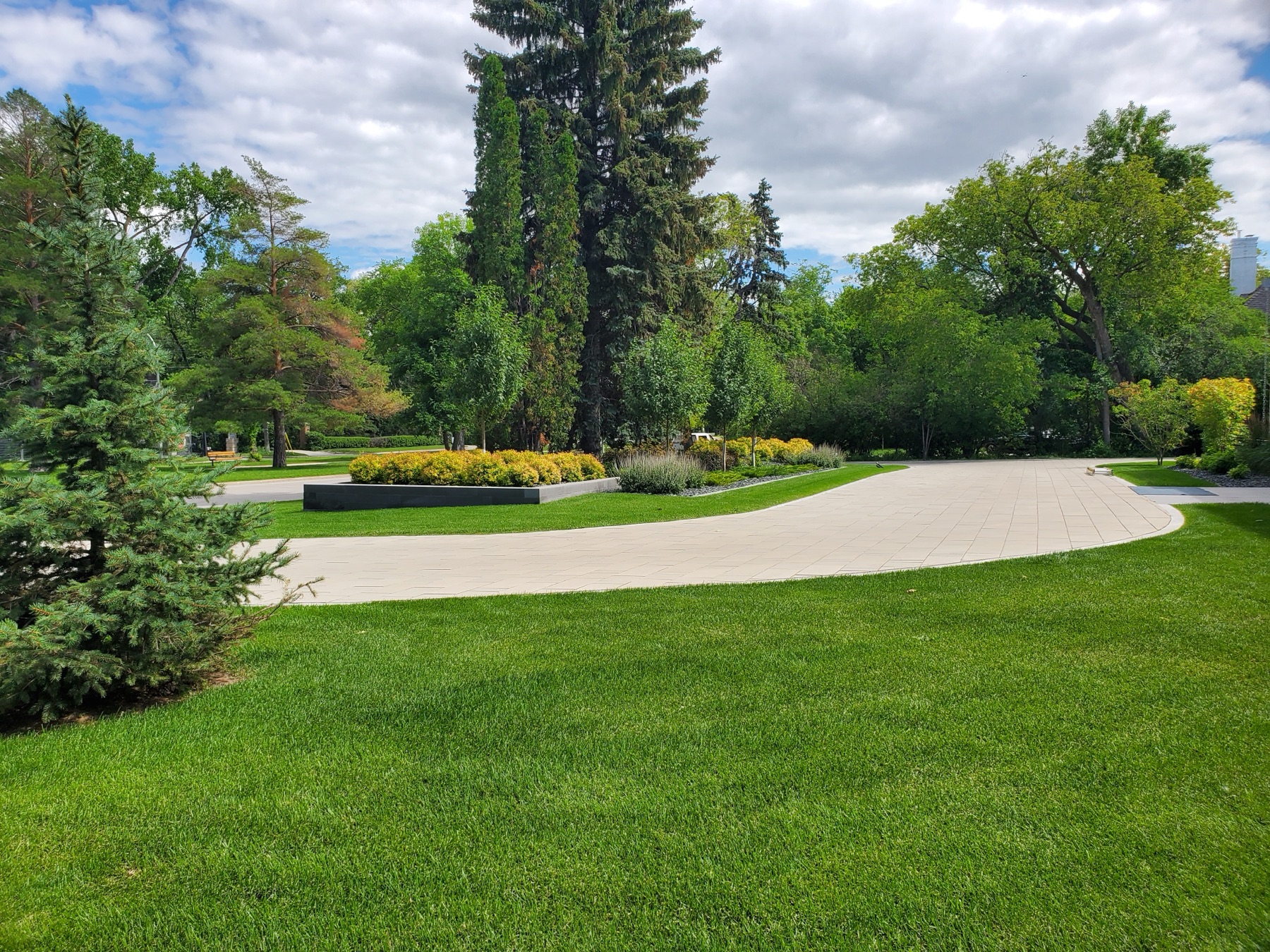 Sweeping maintained lawn with long planted borders