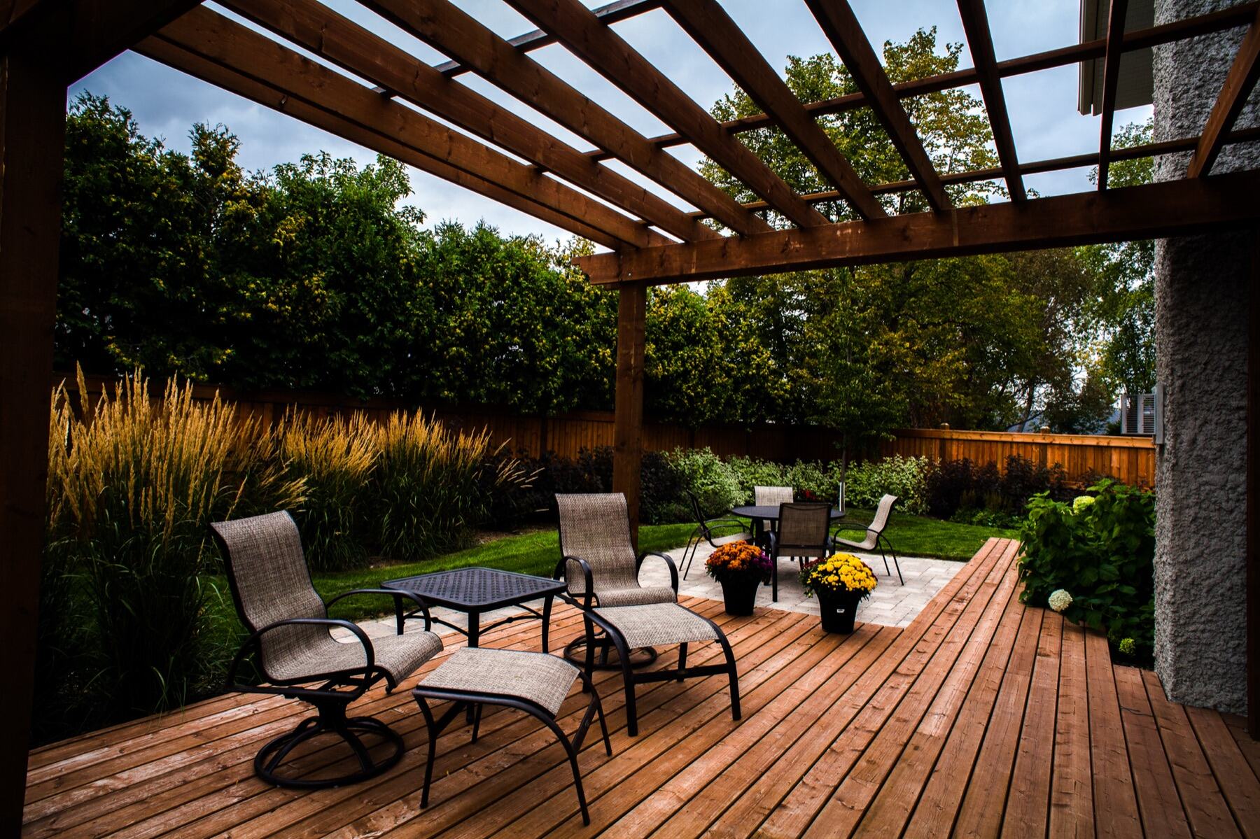 Cedar pergola over a deck with lounge seating