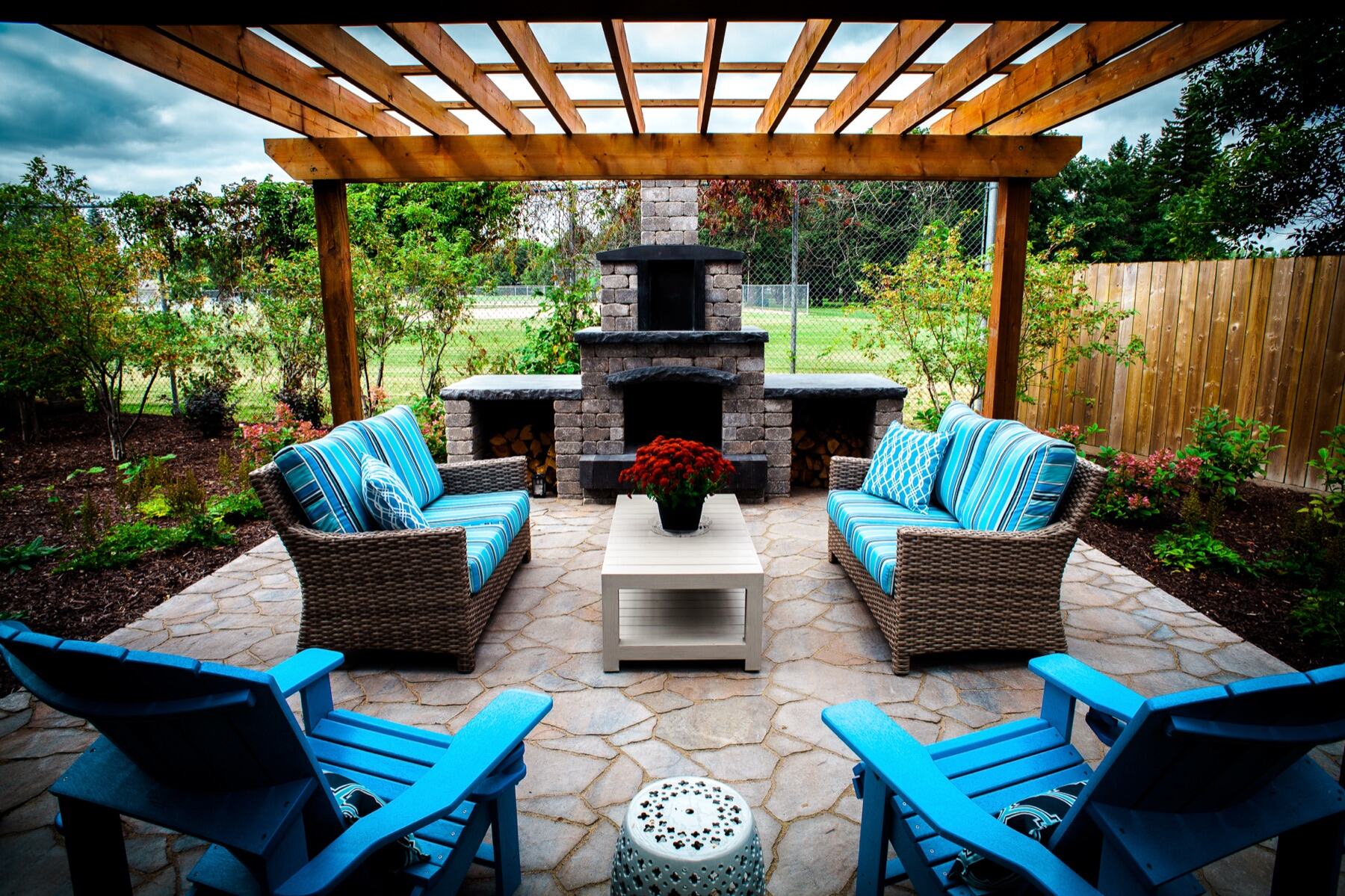 Cedar pergola with outdoor fireplace and lounge furniture