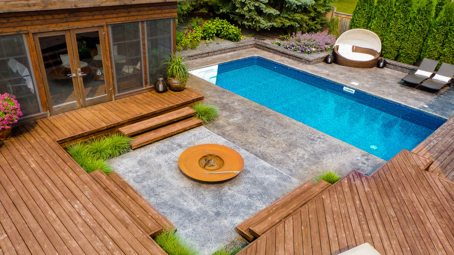 Overhead view of pool, wood deck, and sunken fire bowl