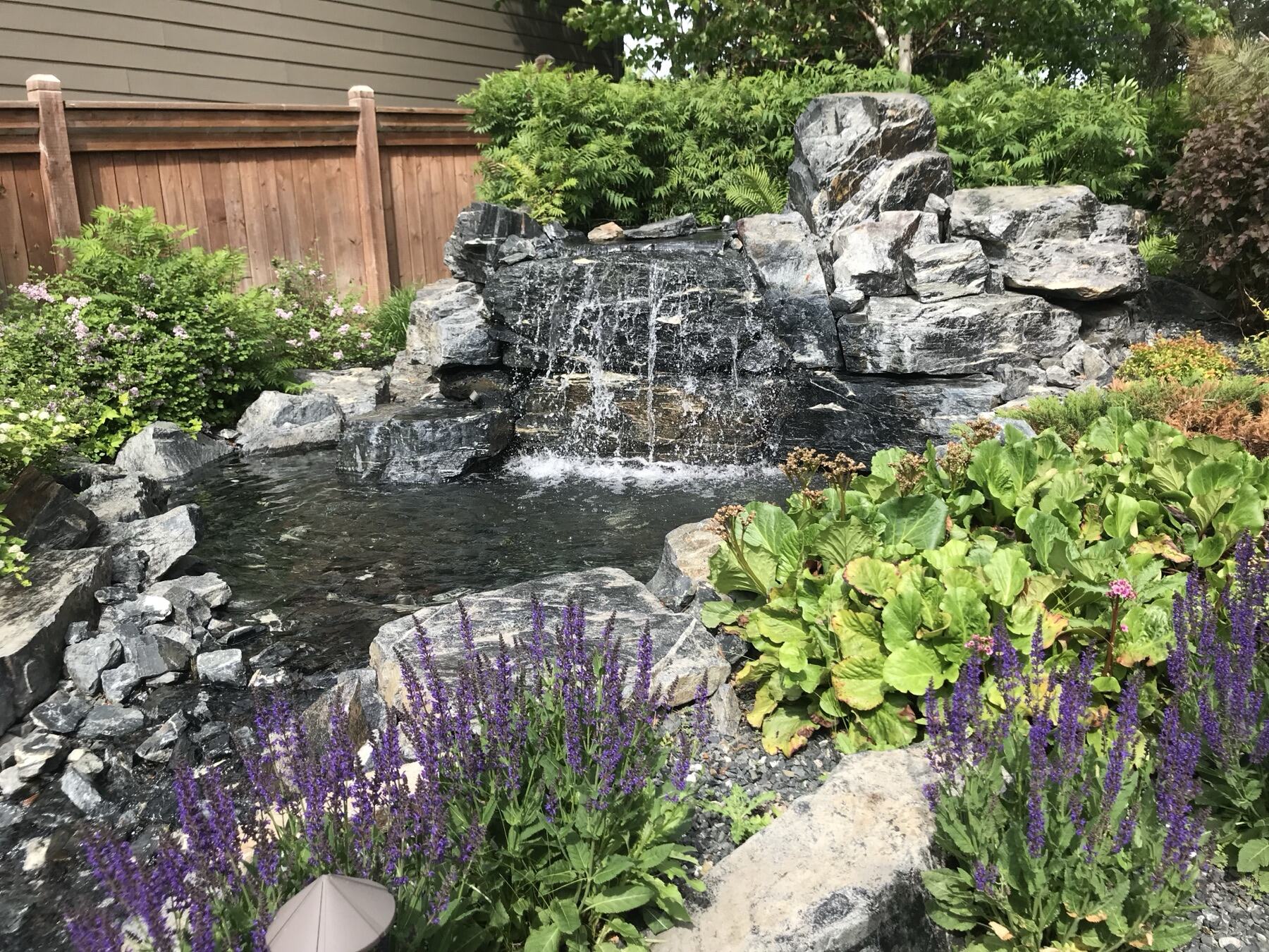 Natural stone waterfall with perennial plantings